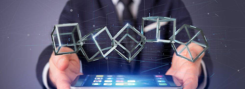 Businessman holding a 3d rendering blockchain cube isolated on a background